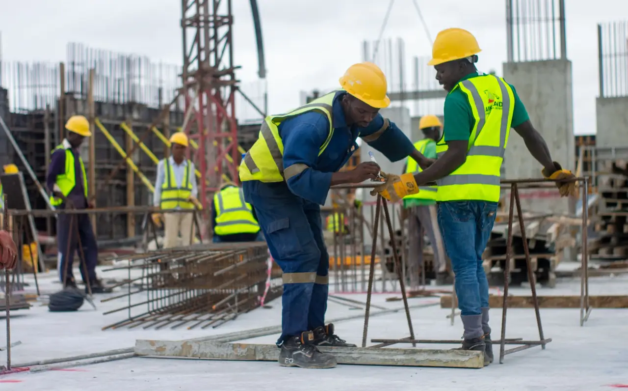 Construction workers wearing hard hats at a building site